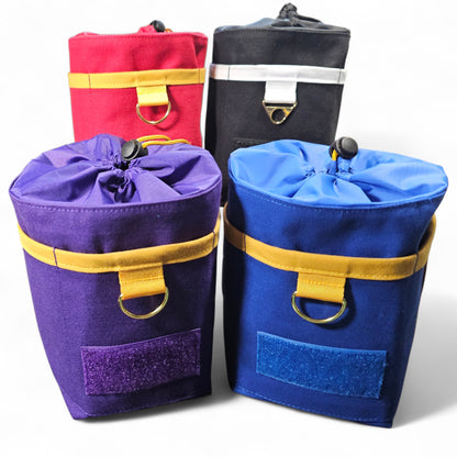 Four colorful drawstring bags in purple, red, black, and blue with yellow straps on a white background.