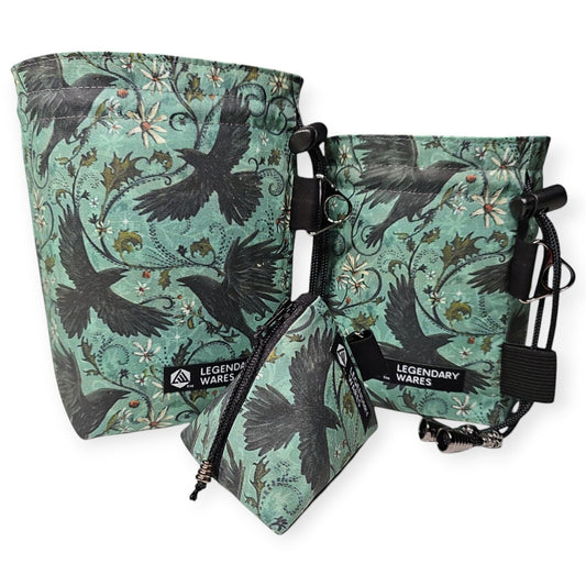 Legendary Wares Ravenflight dice bag set with flying raven pattern on teal background. Includes large and small bags and a dice pouch.